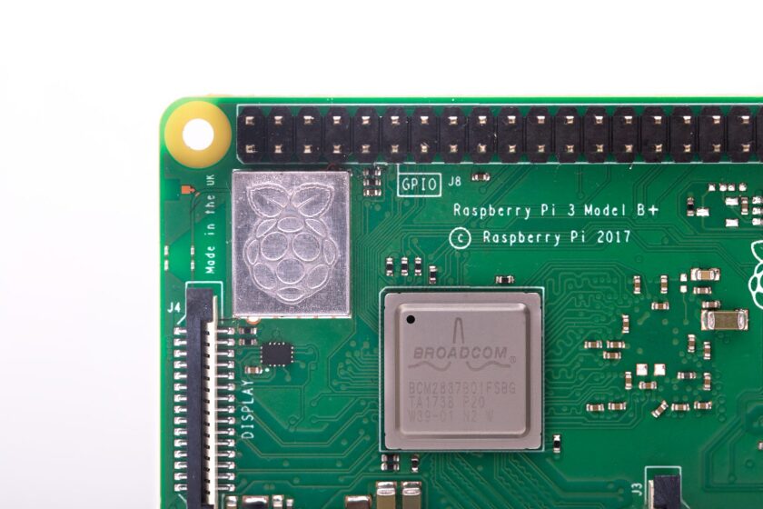 All of the wireless circuitry for the Pi 3 Model B+ is housed under a metal shield that's been embossed with the Raspberry Pi Foundation's logo