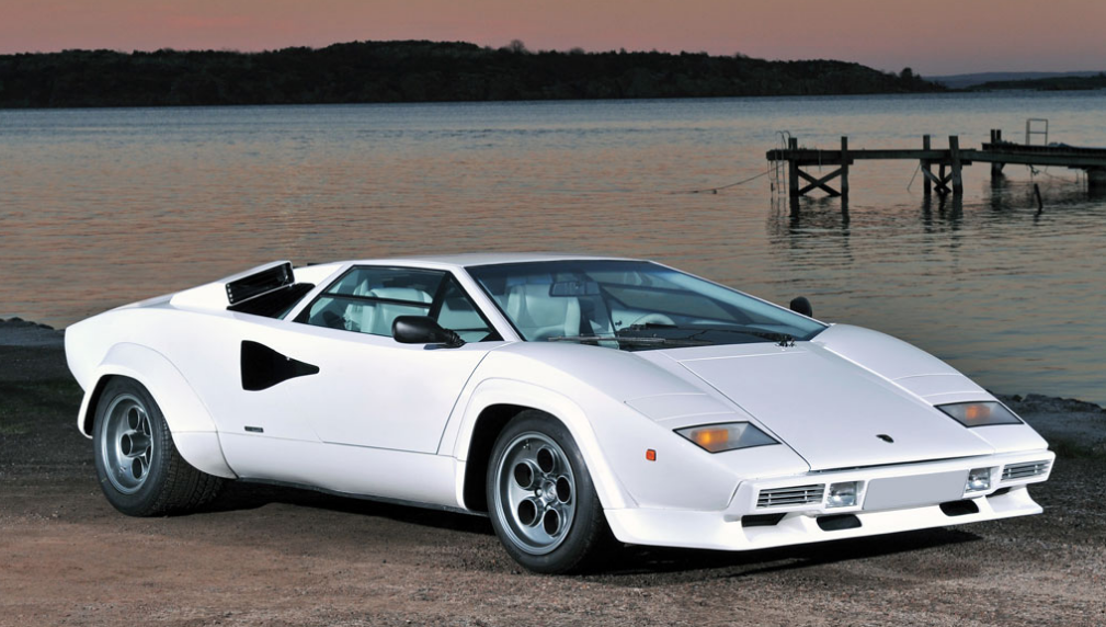 Most modern supercars owe their basic shape to this one extraordinary and outrageous leap in styling, made by Lamborghini and designed by Bertone in 1971: the Lamborghini Countach LP400. It was the first production Lambo to sport what became the brand's trademark scissor doors, and it looked like a polygonal spaceship in a way that no car before it had done, and with its 3929 cc mid-engined V12 delivering 370 hp, it could top 179 mph (288 km/h) on the autostrada.