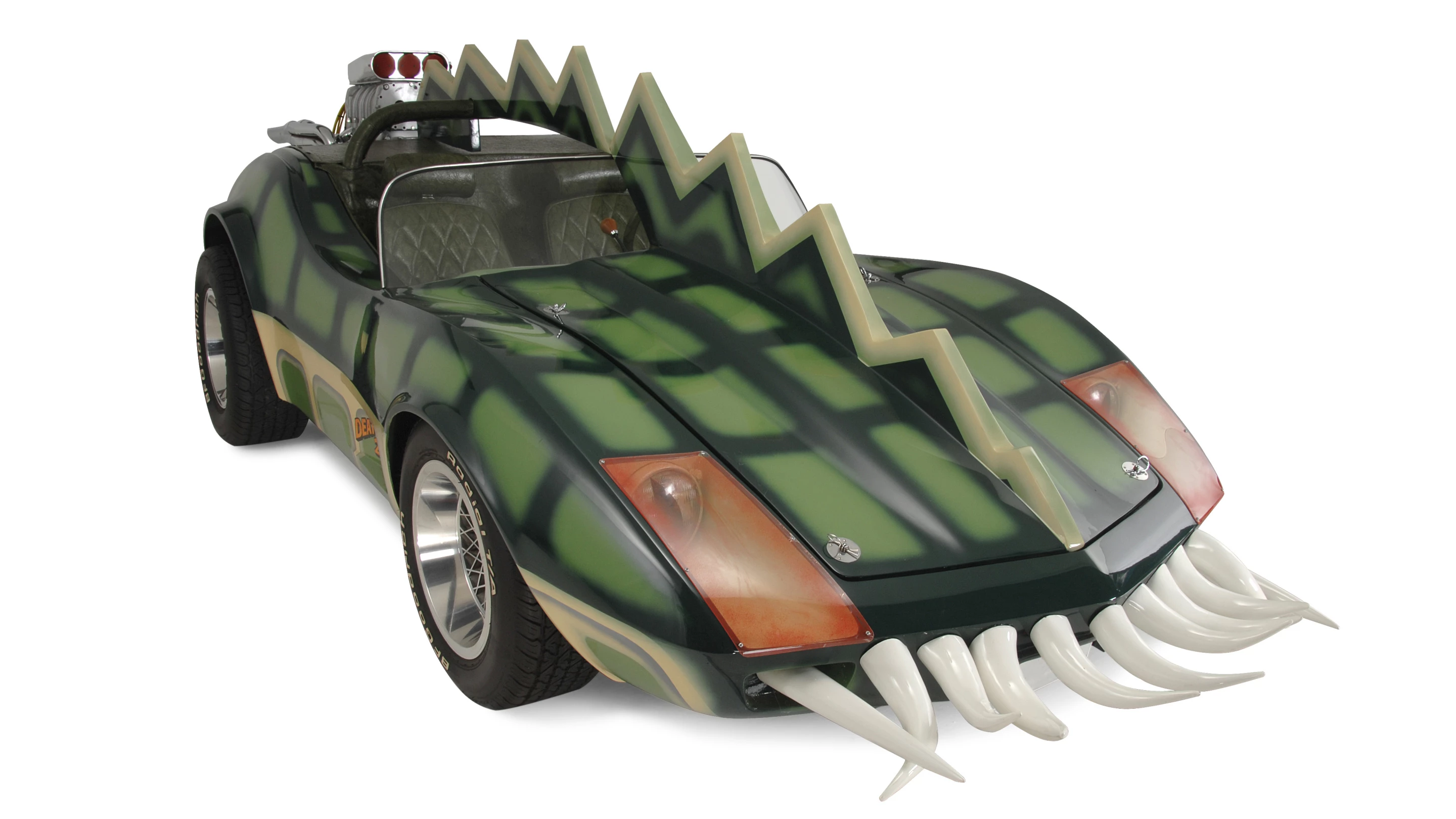 The car that is coming to auction is the Alligator Corvette driven by Carradine in Death Race 2000 (1975). The one-of-a-kind “alligator” Corvette (it's actually a Volkswagen chassis with an air-cooled Corvair motor), is expected to fetch between $20,000 and $25,000, despite the fact it got lots of screen time as Carradine (Frankenstein) fights against his deadly rival Stallone (Machine Gun Joe).