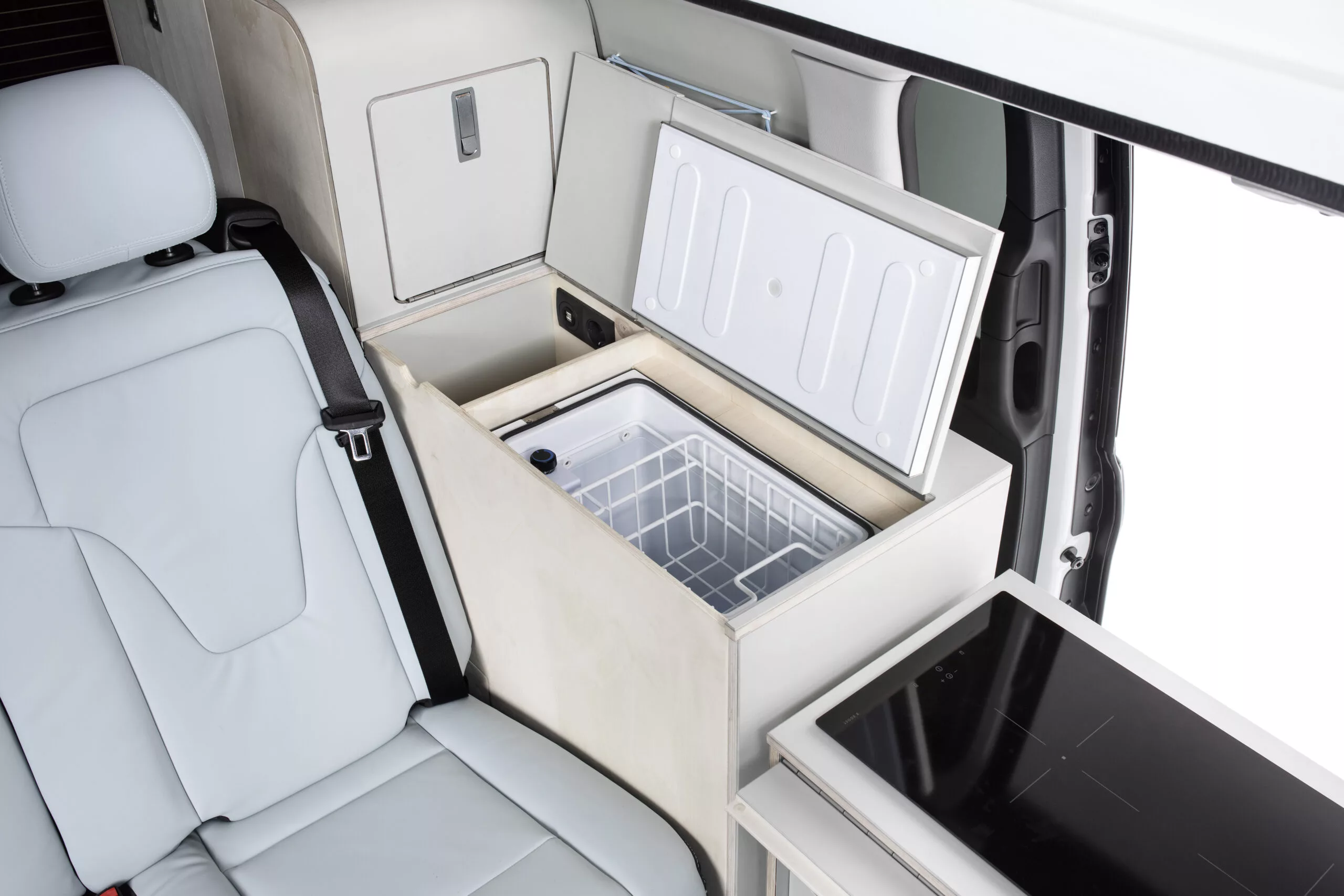 Pictured here in the Mercedes EQV Touring, Tonke's swivel kitchen traditionally pairs a hinged indoor/outdoor front module with a fixed rear fridge