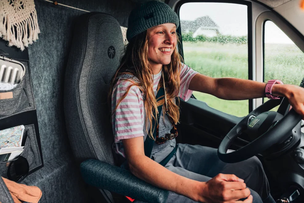 More than just a division between driving and living areas, the wall serves as a functional feature with storage pockets in the cab