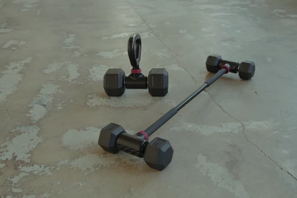 The Hyperbell kettlebell handle and bar, attached to third-party dumbbells