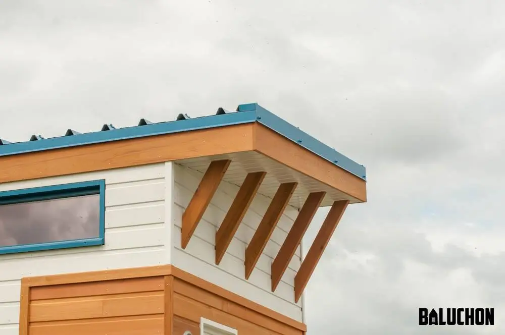 The Valhalla is finished in red cedar with white accenting, and is topped by a teal roof