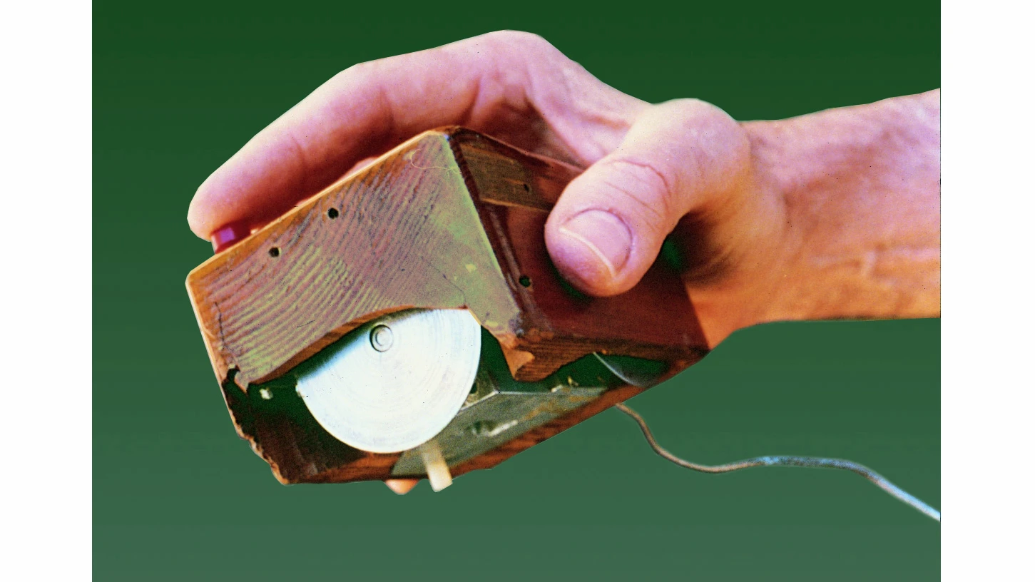 The first computer mouse was made of wood and featured two wheels to control X and Y movement (Image: SRI International)