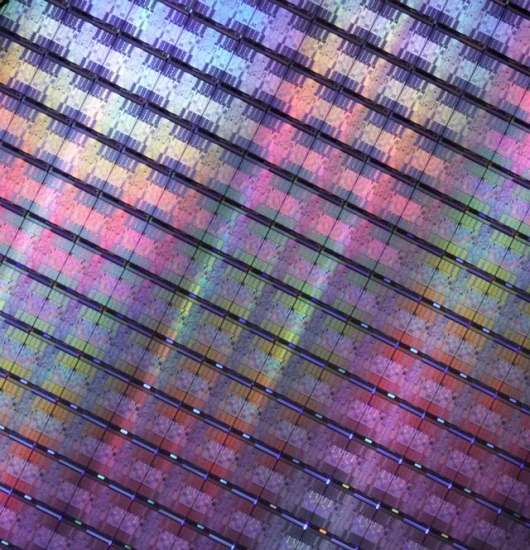 Hundreds of IBM POWER6 microprocessors on a silicon wafer. The wafer is cut into individual chips that are then packaged and then built into new IBM servers that offer twice the performance with virtually no increase in energy consumption. Each chip has t