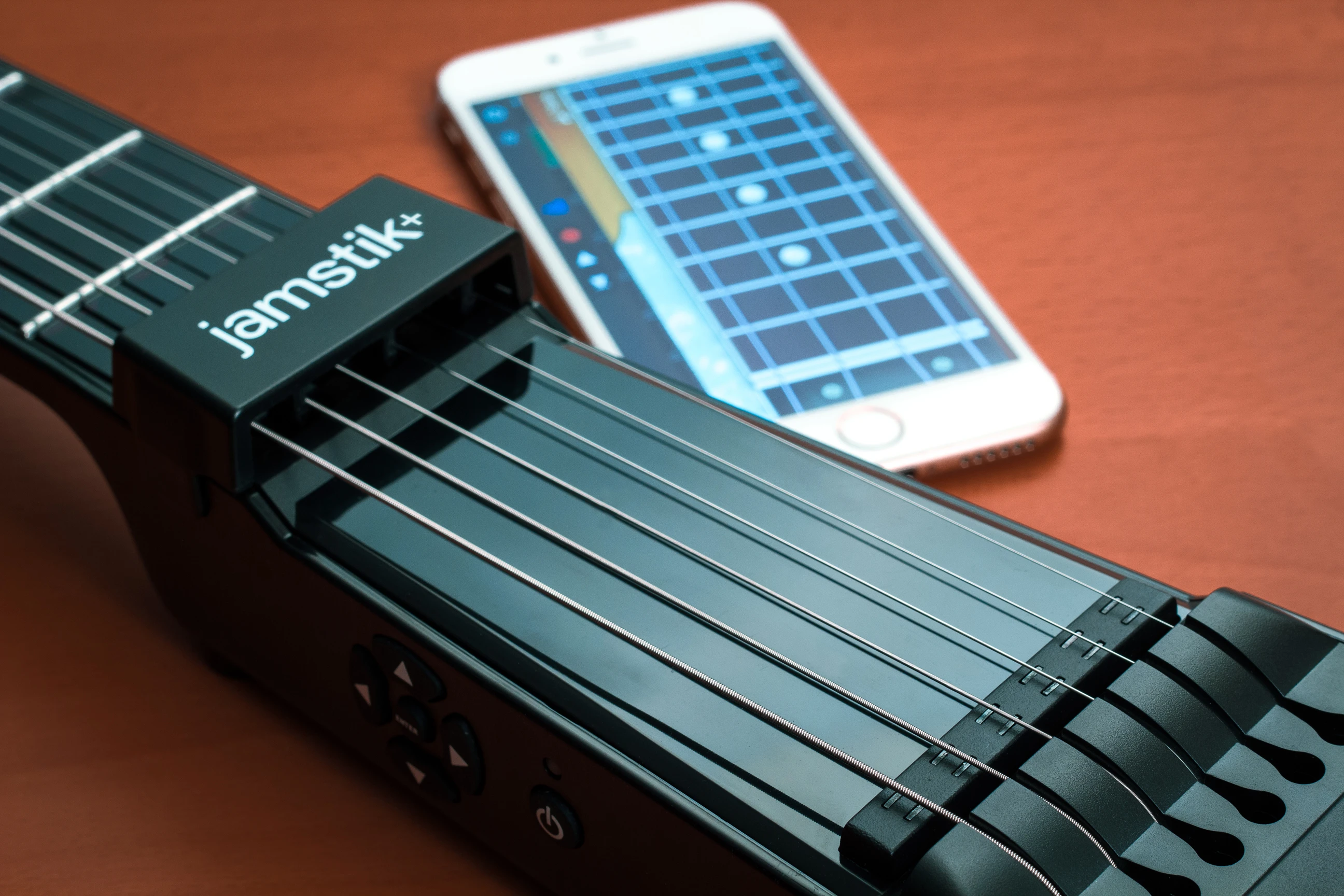 Software running on an iOS device paired over Bluetooth LE translates picking action into sounds