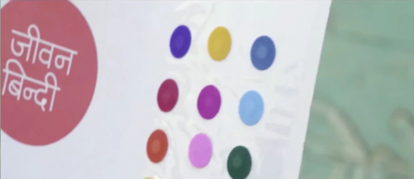 The "life-saving dot" is colorful and self-adhesive, like many other cosmetic bindis available in India