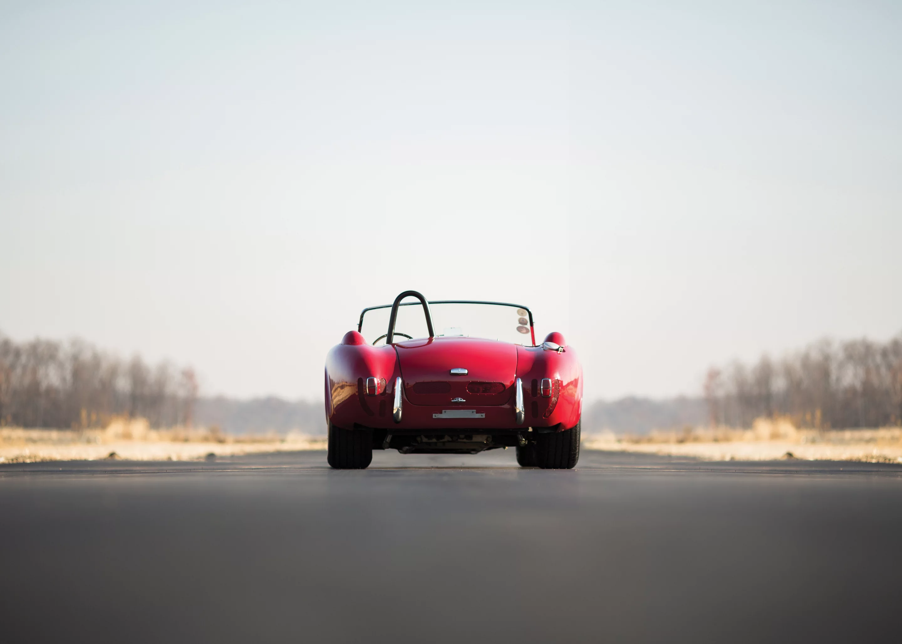 While much has been written about this Cobra, it is most famous for its appearances in promotional pieces for the menswear company, Mr. Formal Wear, the most famous of which depicts a buxom blonde, clad in white tuxedo shirt, bow tie, high heels, and nothing else, chatting on a payphone next to the Cobra before two astonished onlookers. Another piece, famously titled “Some Guys Have It Tough,” depicts the Cobra beachside, with its driver and his lovely passenger skinny-dipping in the distance. Those posters appeared on bedroom and workshop walls all over the country and became legend among Cobra enthusiasts. This is THAT car. It sold for $990,000.