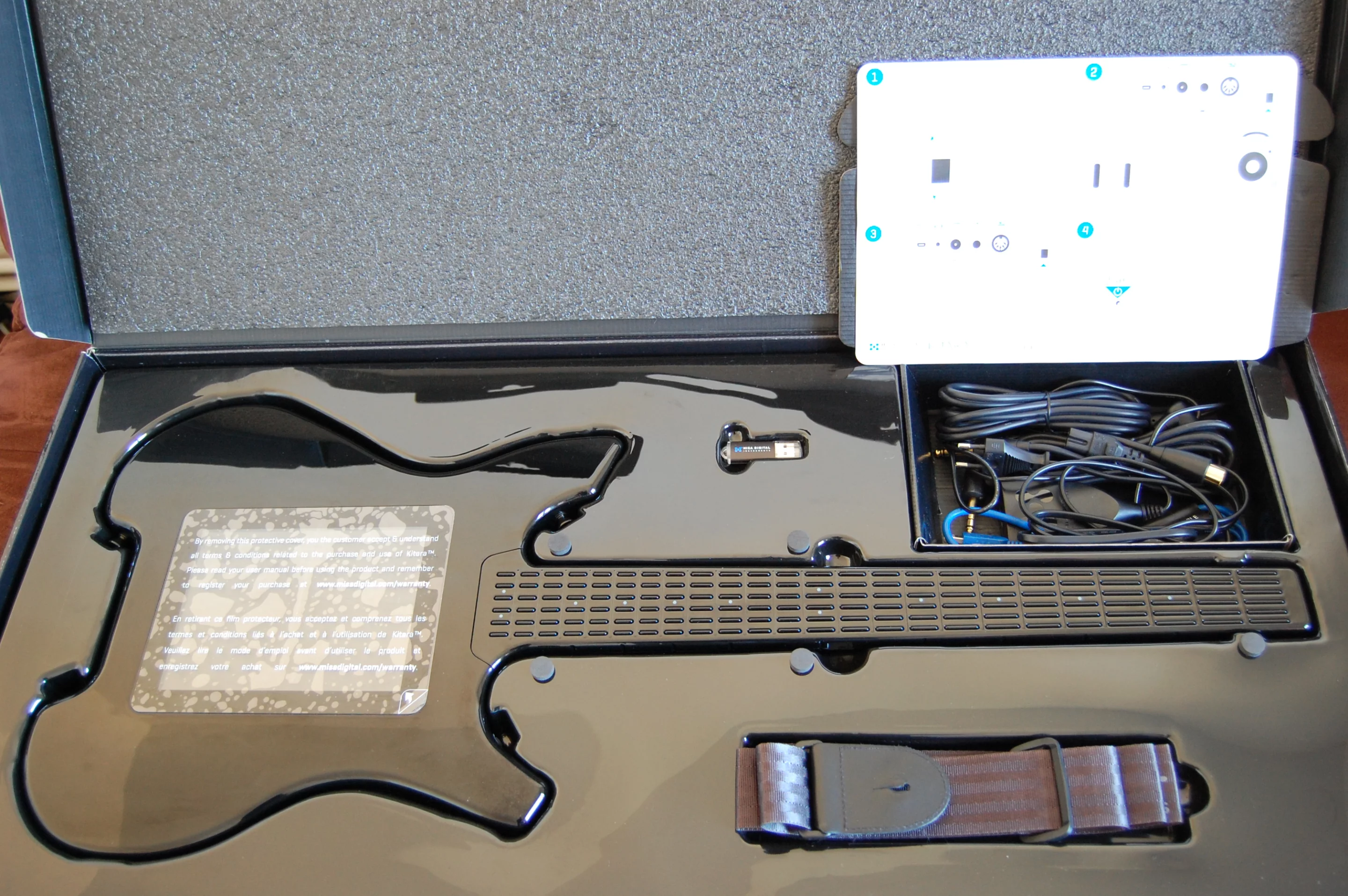 In addition to the instrument, the box contains leads, a strap, a USB stick containing a user manual, a quick start guide, a cleaning cloth and spare screen protectors