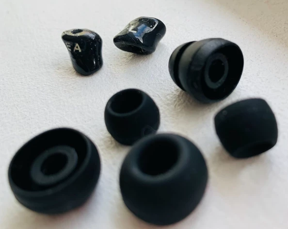 To the rear, custom-fit earphone tips unique to each user for a secure fit (shown with standard silicone buds provided with regular earphones)