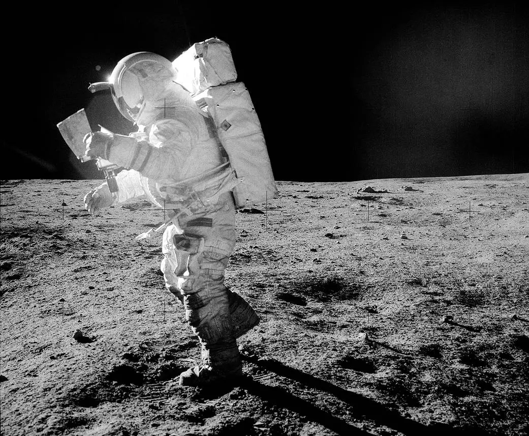 Astronaut Edgar Mitchell pictured walking across the Moon's surface in a spacesuit contaminated by lunar regolith