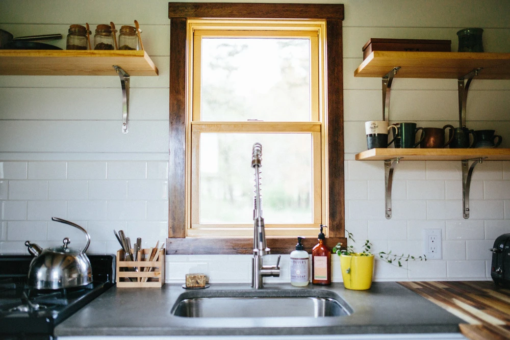 The relatively large looking kitchen includes a four-burner cooktop and oven