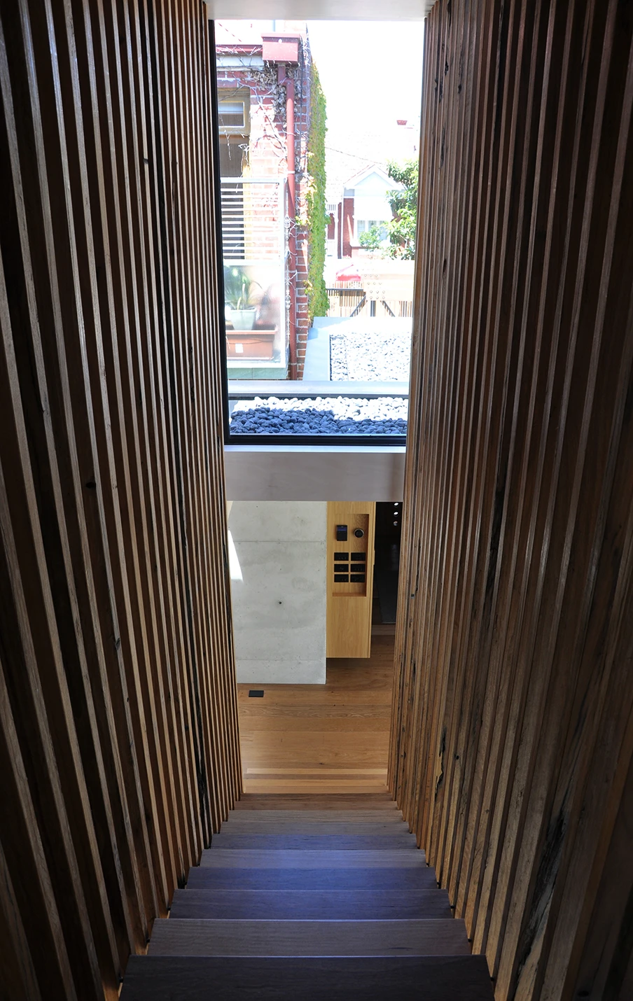 Recycled tallowwood was used for the home's interior flooring, windows, staircases and striking external cladding (Photo: Edoardo Campanale for Gizmag)