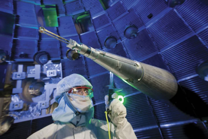 A NIF technician checks the target positioner, which precisely centers the target inside the target chamber (Image: NIF)