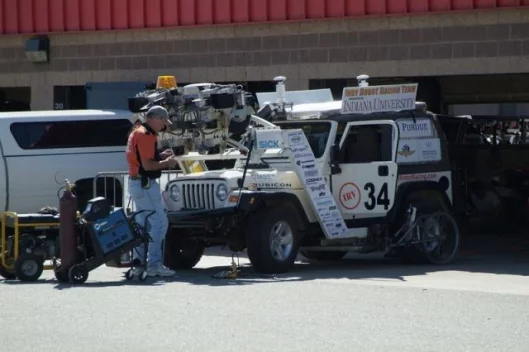 Indy Robot Racing’s 2005 Jeep Rubicon uses a combination of LIDAR and RADAR sensors, structural light detectors, mounted road-following cameras and a drive-by-wire system.