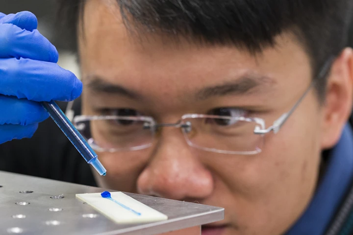 William Wong places a drop of water on the material