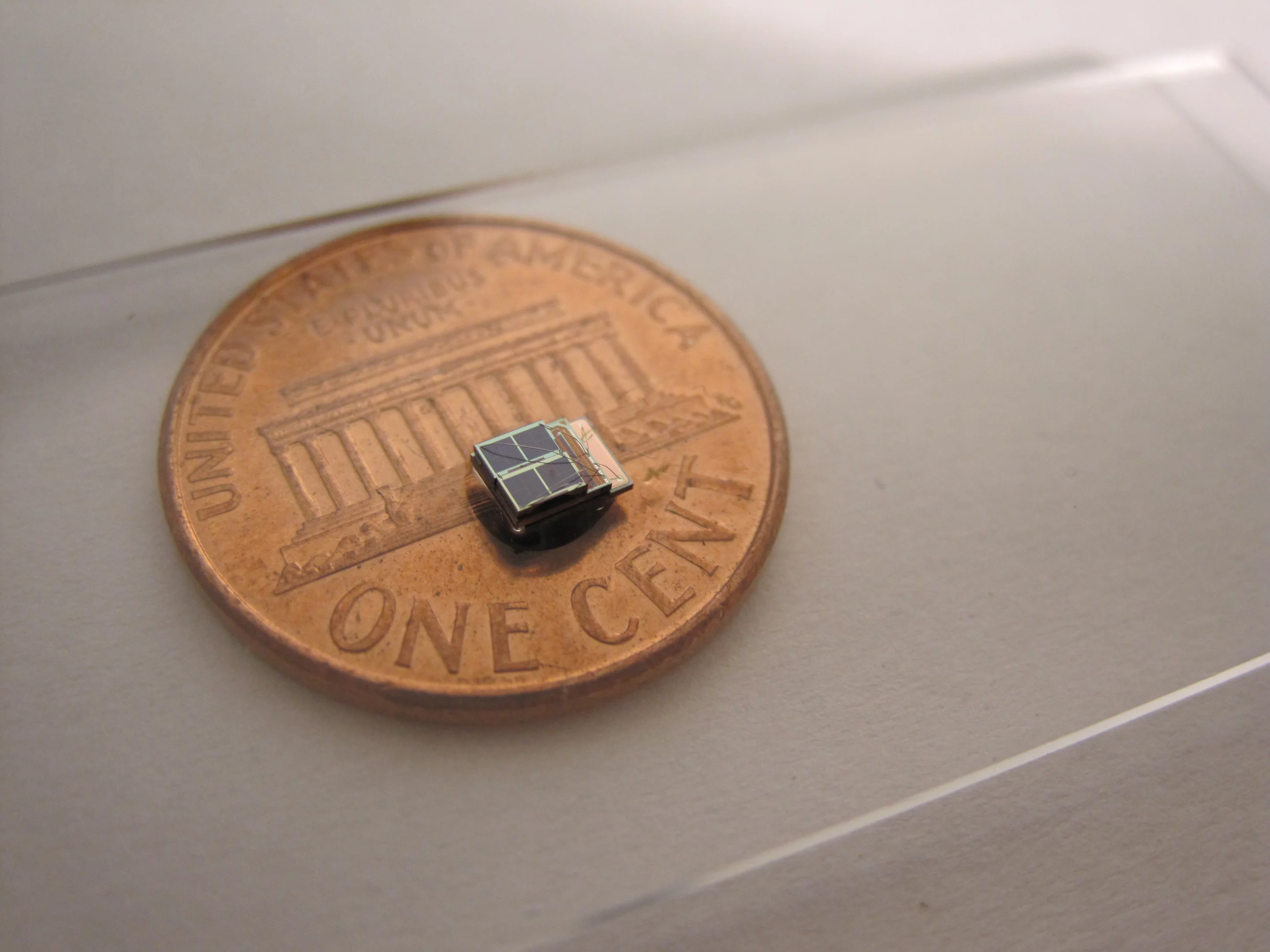 A low-power sensor system developed at the University of Michigan is 1,000 times smaller than comparable commercial counterparts. It could enable new biomedical implants. Photo (Daeyeon Kim)