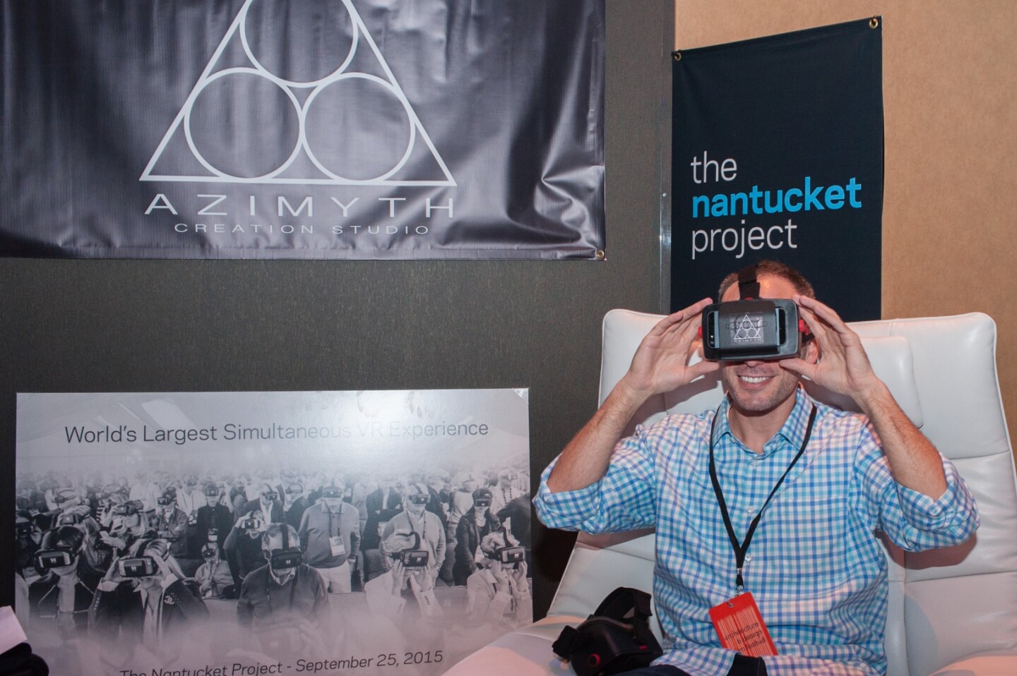 A film festival attendee watches a short film with a VR headset in the Azimyth Immersive Lounge