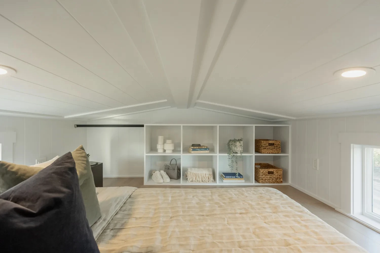 The Ventura Park Model Tiny Home's loft-style bedrooms include some storage space