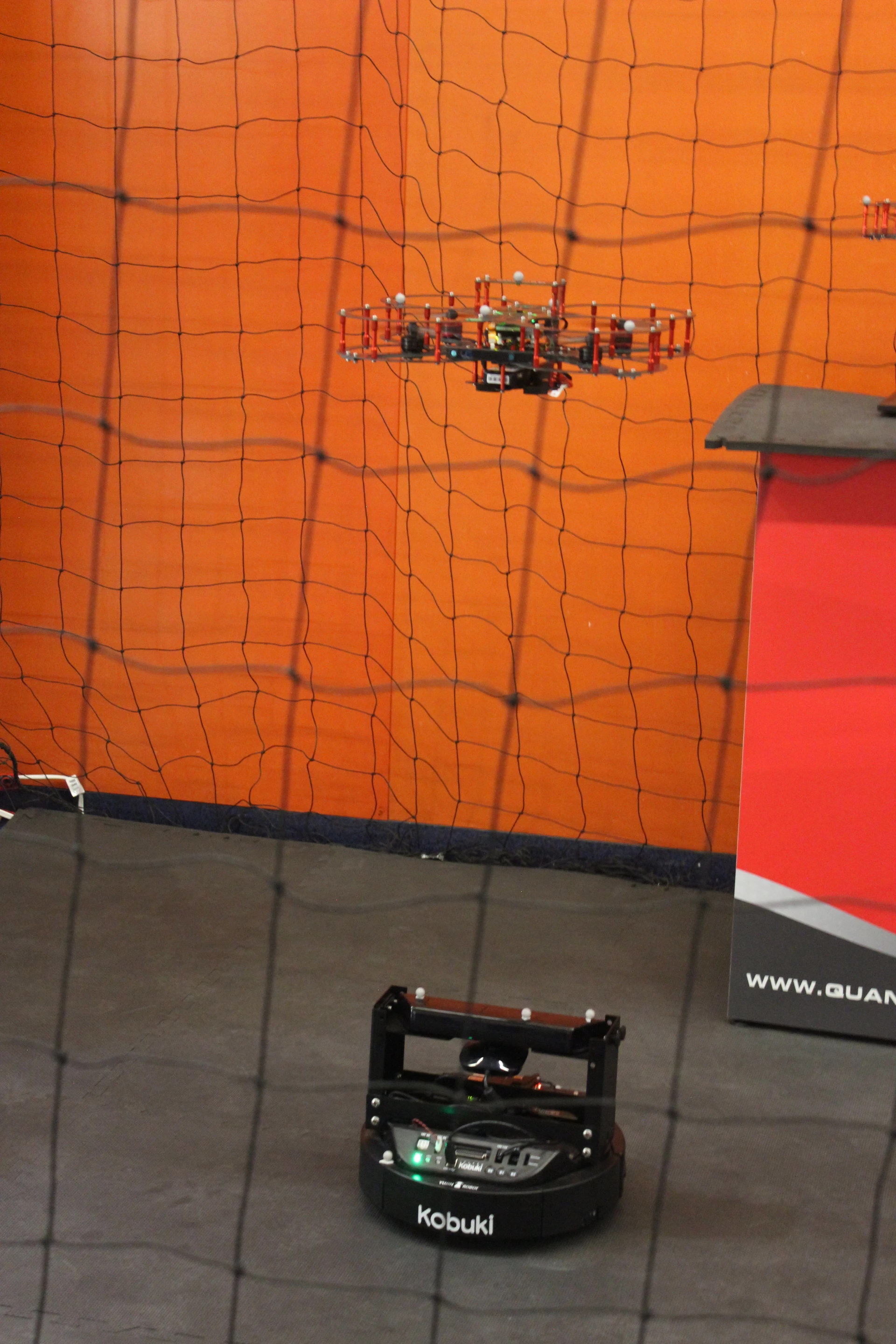 Quanser Lab Solutions was demonstrating this system, in which a ground-based QBot transmits its location to a quadcopter drone that follows along above it – it's a small-scale demo of a system that could be used in the military
