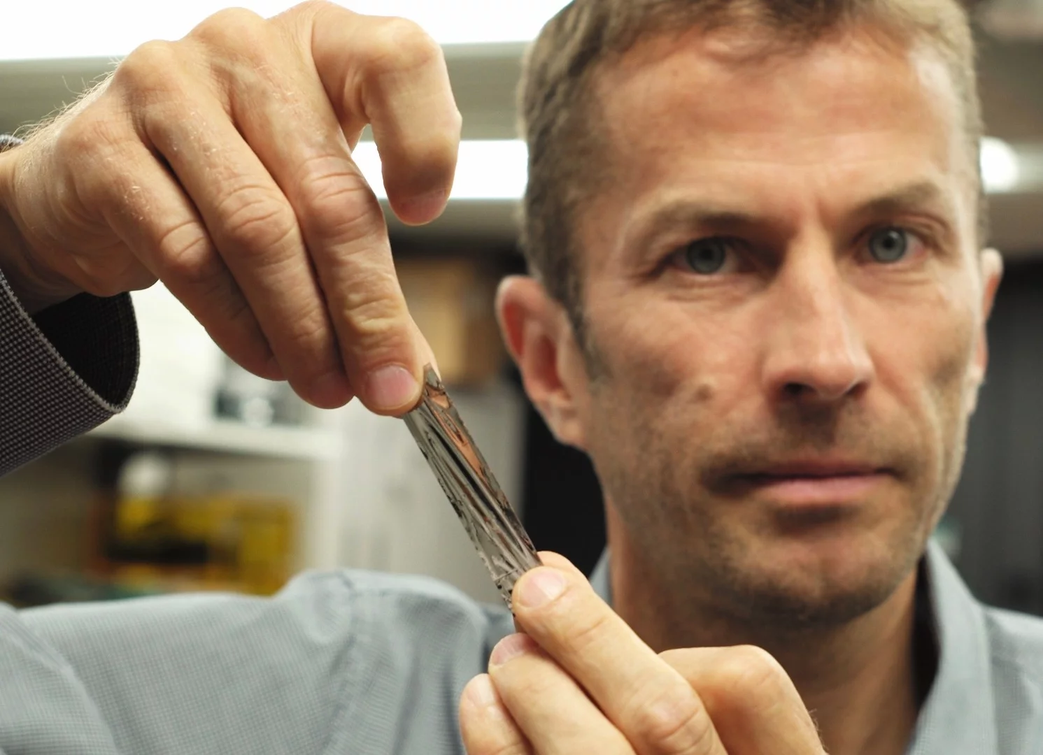 IBM scientist Mark Lantz holding a sample of the new high-density magnetic tape