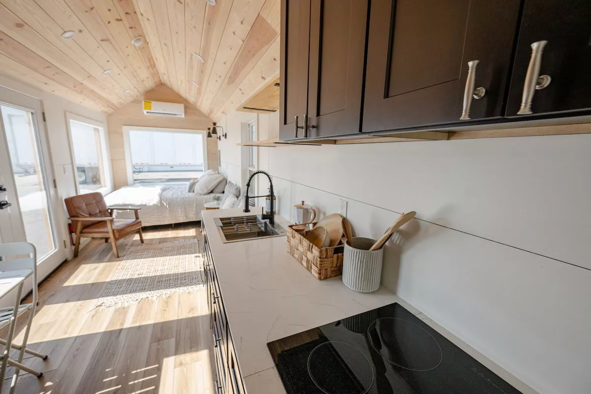 The 28' Model Tiny's kitchen includes an induction stove, sink and a fridge/freezer (not pictured)