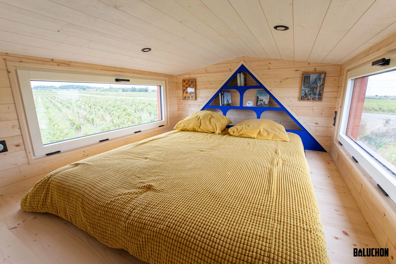 Leïla's tiny house's bedroom is a typical loft-style tiny house space with a low ceiling and a double bed