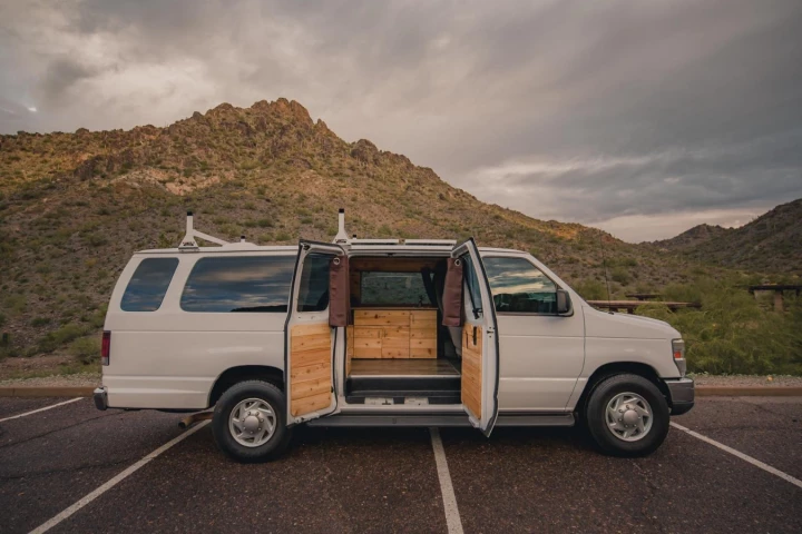 A big, old extended Ford E-350 Boho camper van known as Rev-Van