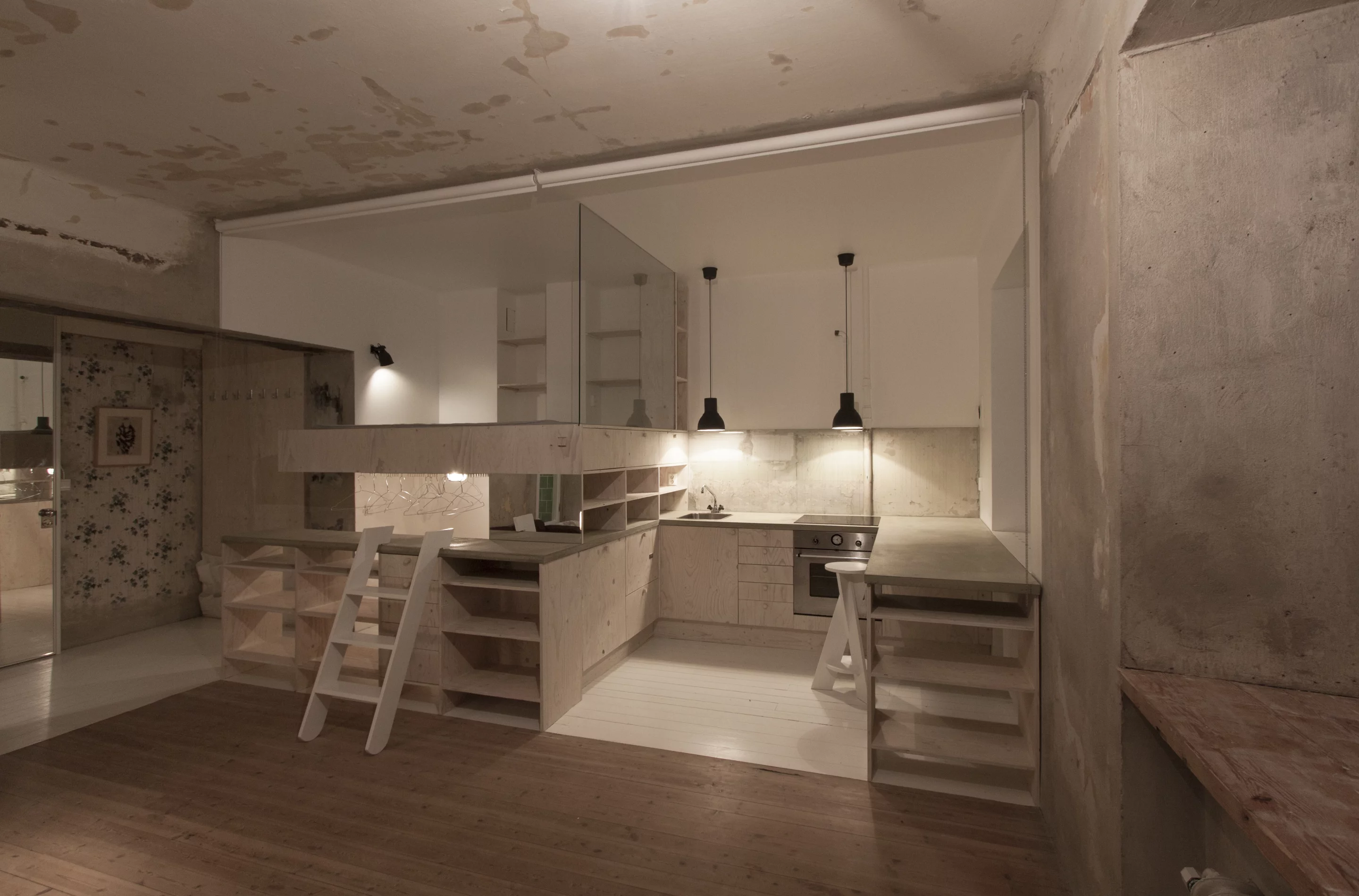 Using pine-plywood Matz based the design of the kitchen and bed area on an IKEA unit