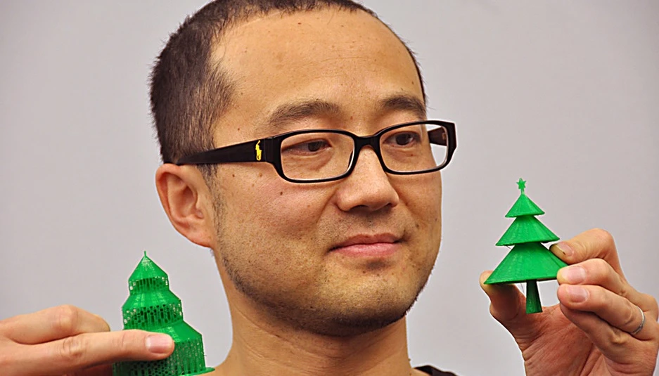 Professor Zhang compares a traditionally 3D-printed Christmas tree, on the left, with one produced using his 3D printing algorithm, right (Photo: Simon Fraser University)