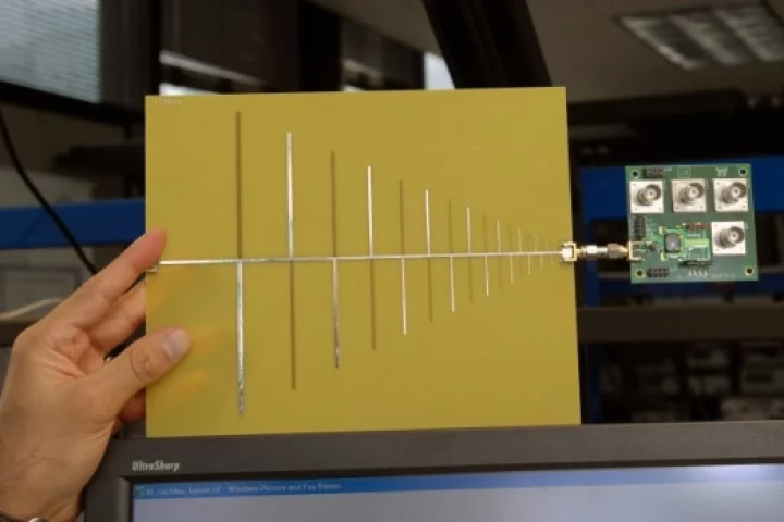 RF cochlea, a low-power, ultra-broadband radio chip attached to an antenna. (Credit: Donna Coveney/MIT)