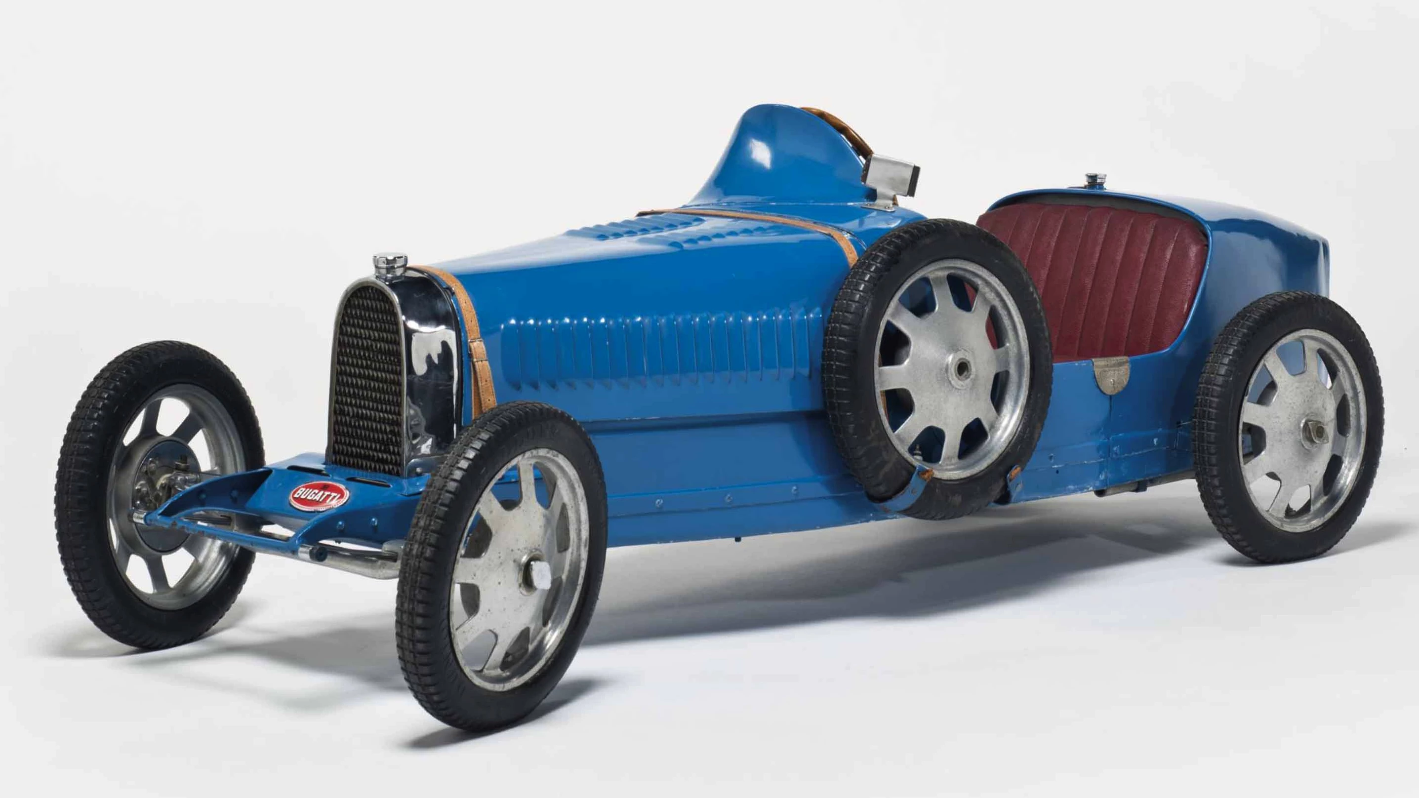 This Bugatti Baby Type 52 electric children’s car was built in 1930 and was one of four such cars purchased new by Fritz Schlumpf, one of the brothers whose automobile collection became the basis for the French National Automotive museum Cité de l'Automobile. This car was auctioned by Christie’s in 2015, selling for €111,900. Two of the four cars are now in the La Cité de l'Automobile in the Collection Schlumpf in Mulhouse. The fourth "short chassis" Bugatti Baby from the Schlumpf collection was sold during the Estate sale of Arlette Schlumpf by Gasser Audhuy in 2009 for €65,000 (US$90,929).
