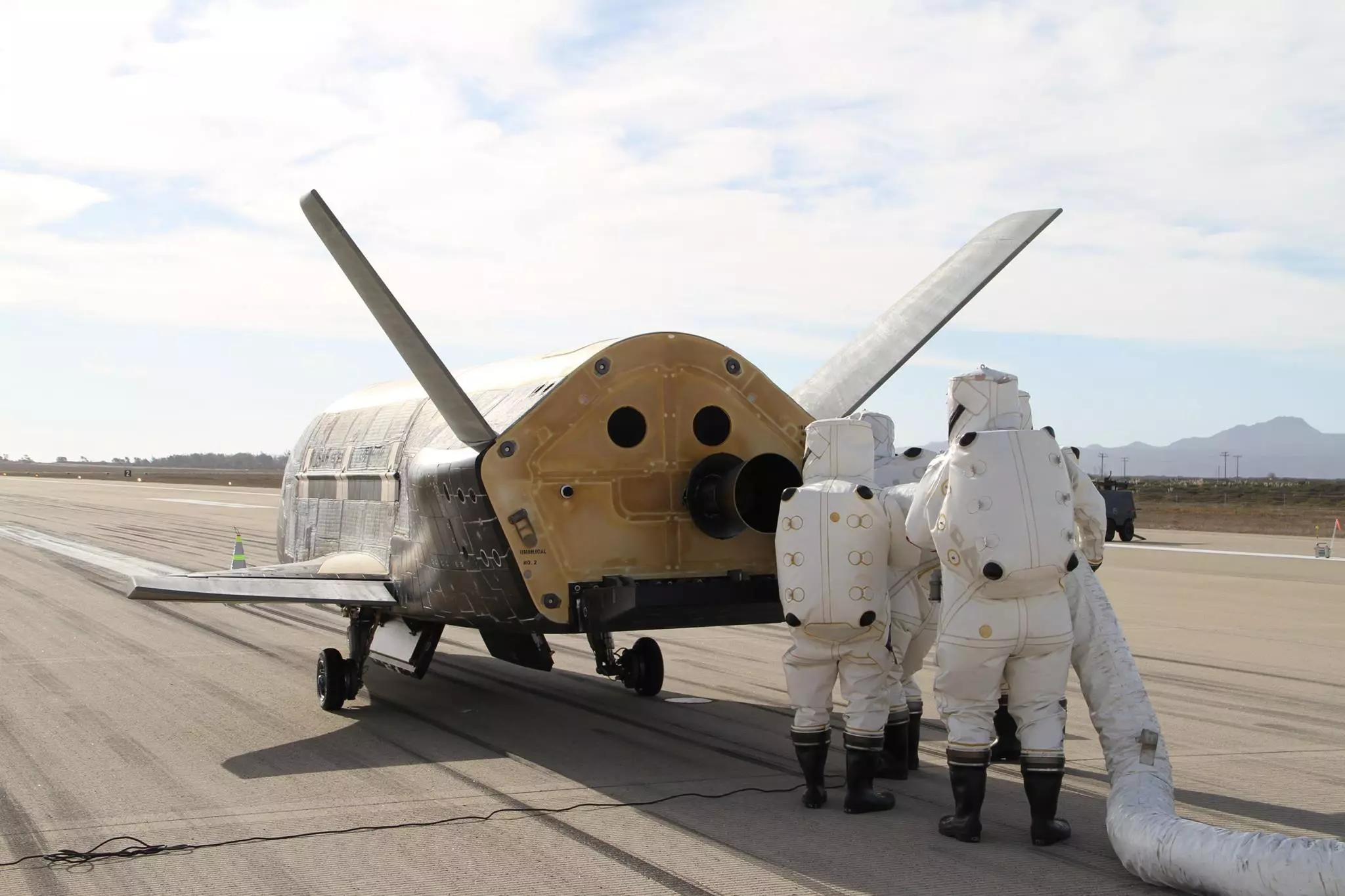 Technicians in hazmat suits inspecting the X-37B (Image: Boeing)