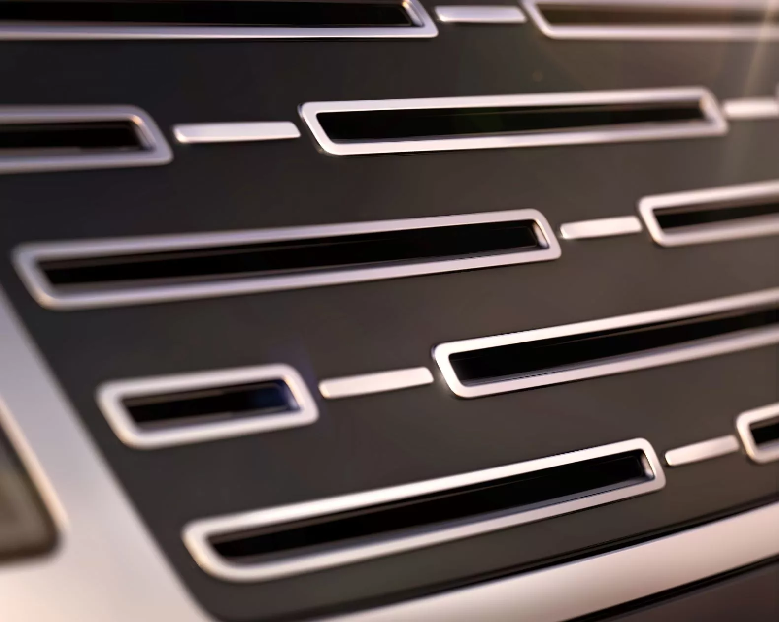 This one appears to be a new "electric" interpretation of the current Range Rover grille, with flat black surfaces where other Range Rover models have open vents