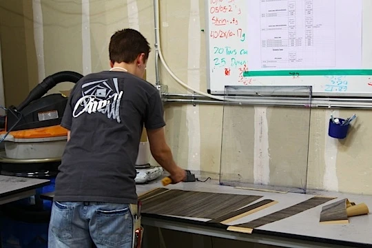 A North Sails employee continuously checks tape material weight