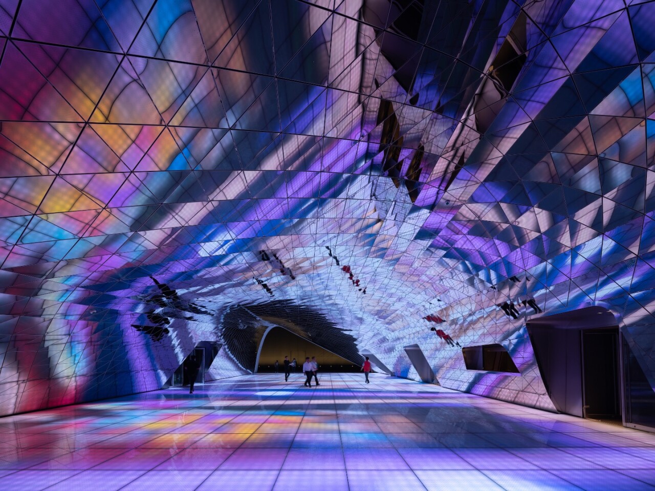 Visitors enter into the Imprint's nightclub into a psychedelic corridor that has screens installed in the floor and a mirrored ceiling and walls