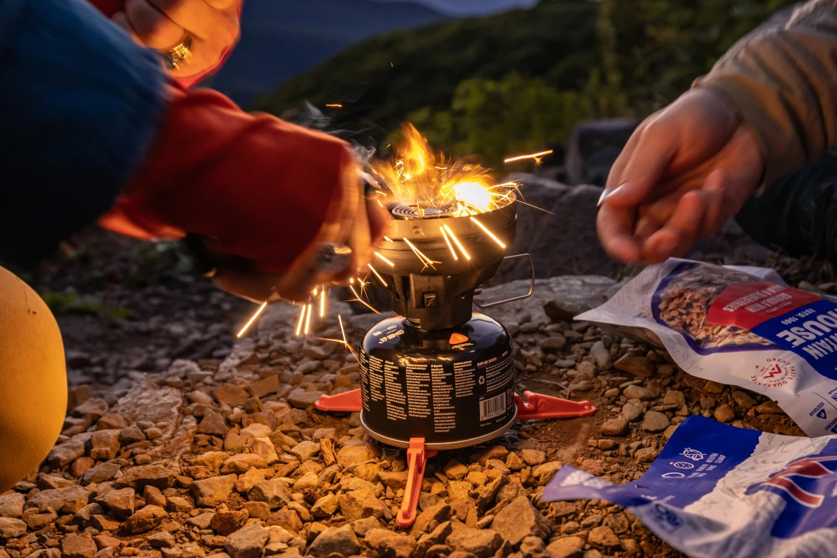 It won't always be a survival fire in the backcountry; here an adventurer uses the Gerber Stakeout Spark's fire-starting to light their backpacking stove