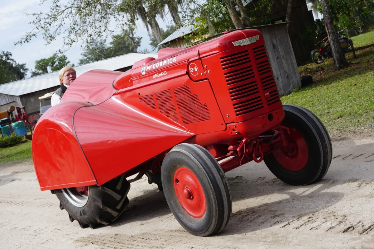 This exotic looking machine is a McCormick Orchard Tractor. Extra slim with exotic looking bodywork designed to travel thru orchard isles, orchard tractors are prized by collectors