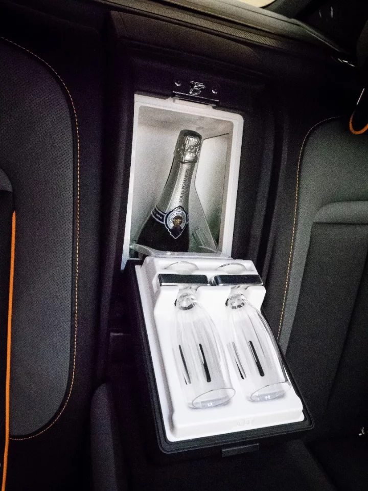 Rolls-Royce Cullinan: between the rear seats in the four-seat model, there's a champagne fridge. It's perfectly legal to have open bottles of alcohol in a car in the UK. How about that.