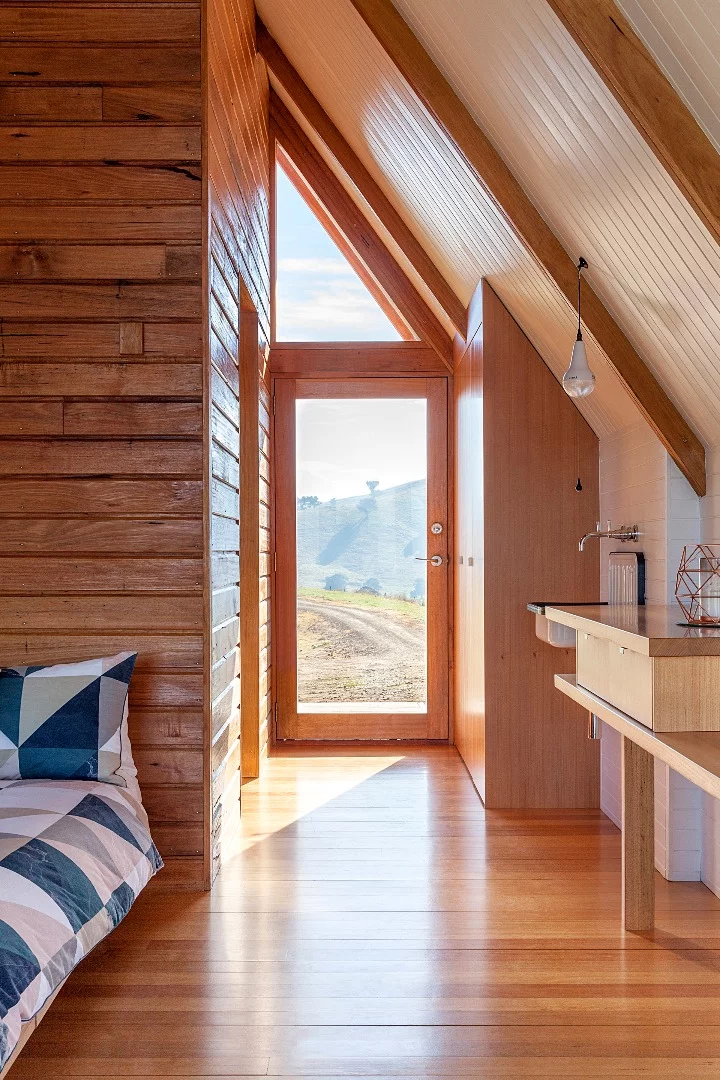Inside the solar-powered JR's Hut is a bed for two, bathroom with a view and freestanding wood burner fireplace