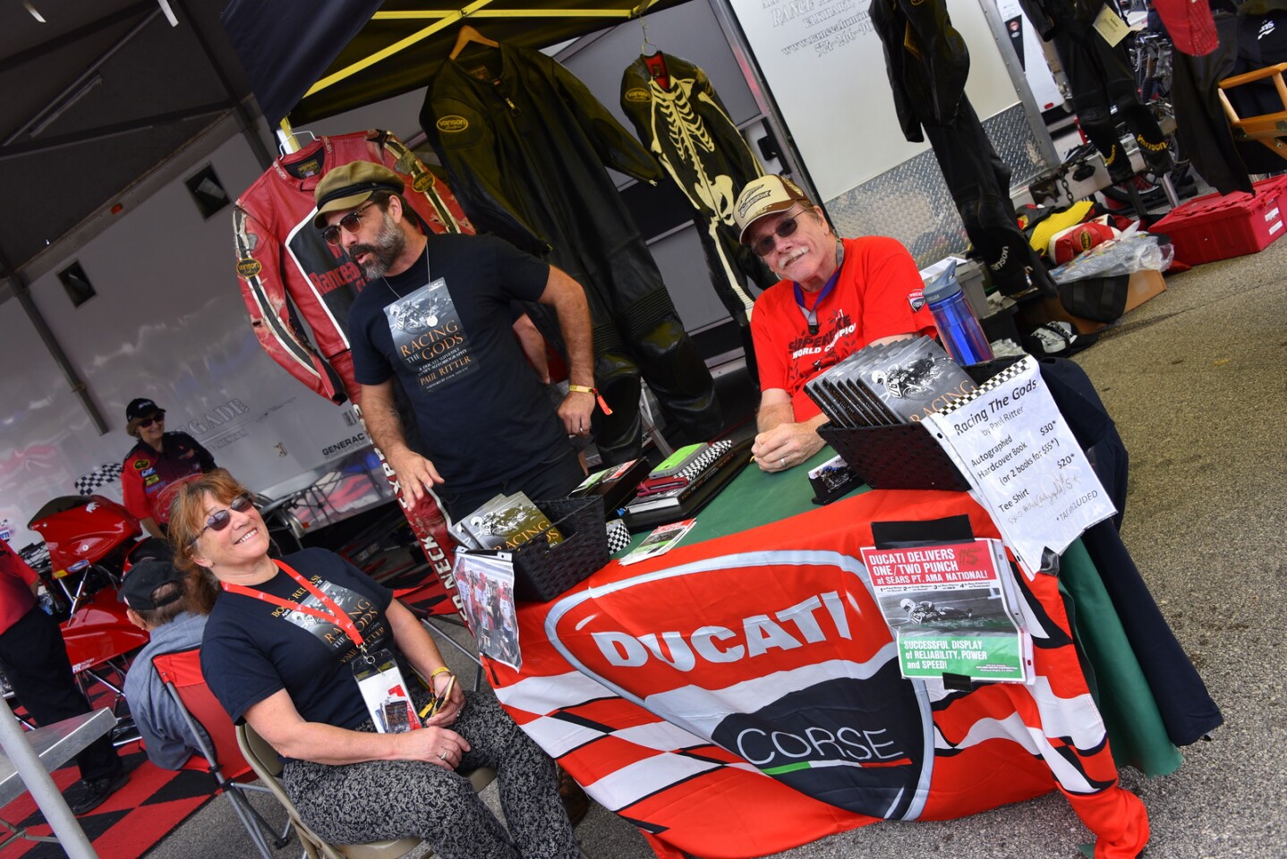 Former Superbike racer (and now accomplished author) Paul Ritter selling his book in the AHRMA paddock