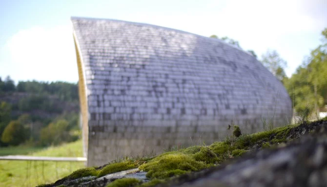 Protected from the elements, the exterior walls and roofing have a surface layer of biodegradable, cellulose-based, reinforced board which is wind and water resistant