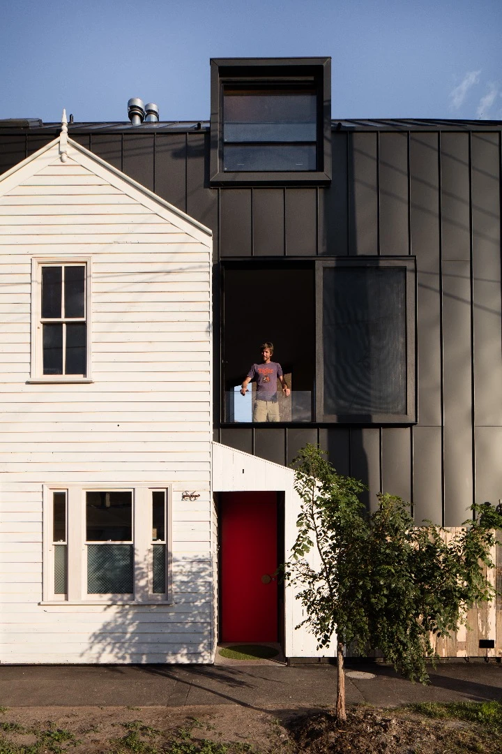 Full-height sliding doors and screens open up the main living area of the Acute House to the elements