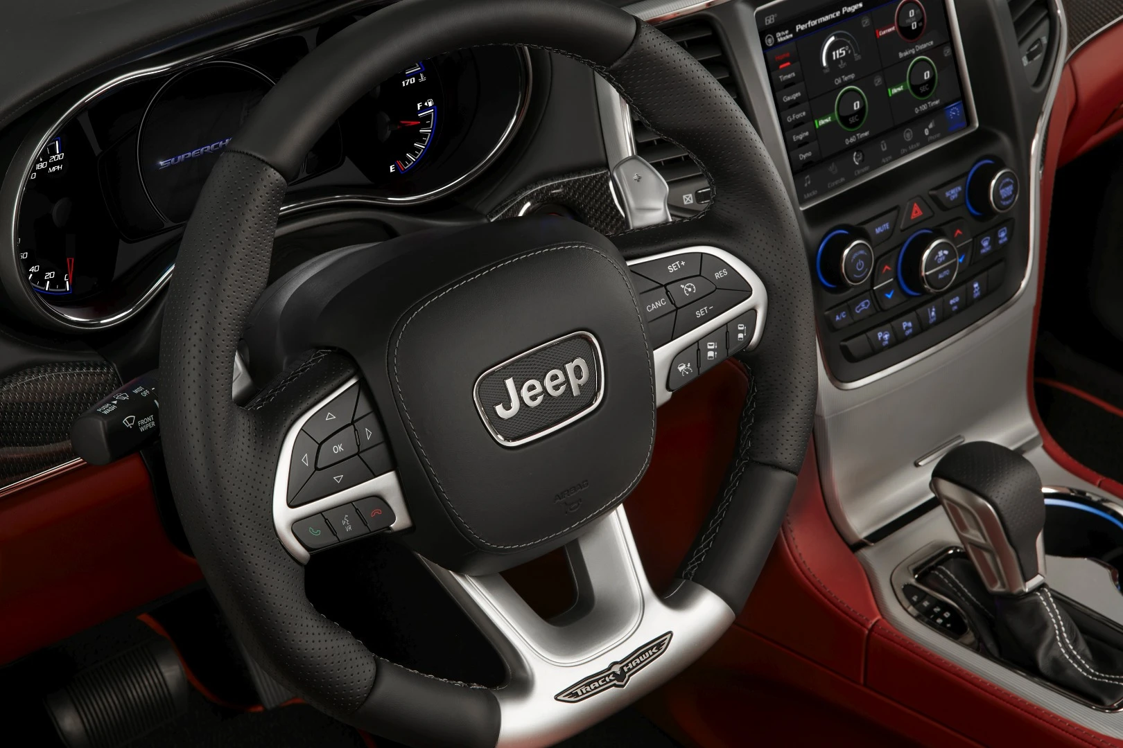 The Trackhawk has a three-spoke steering wheel with a flat-bottom, built-in controls and paddle shifters