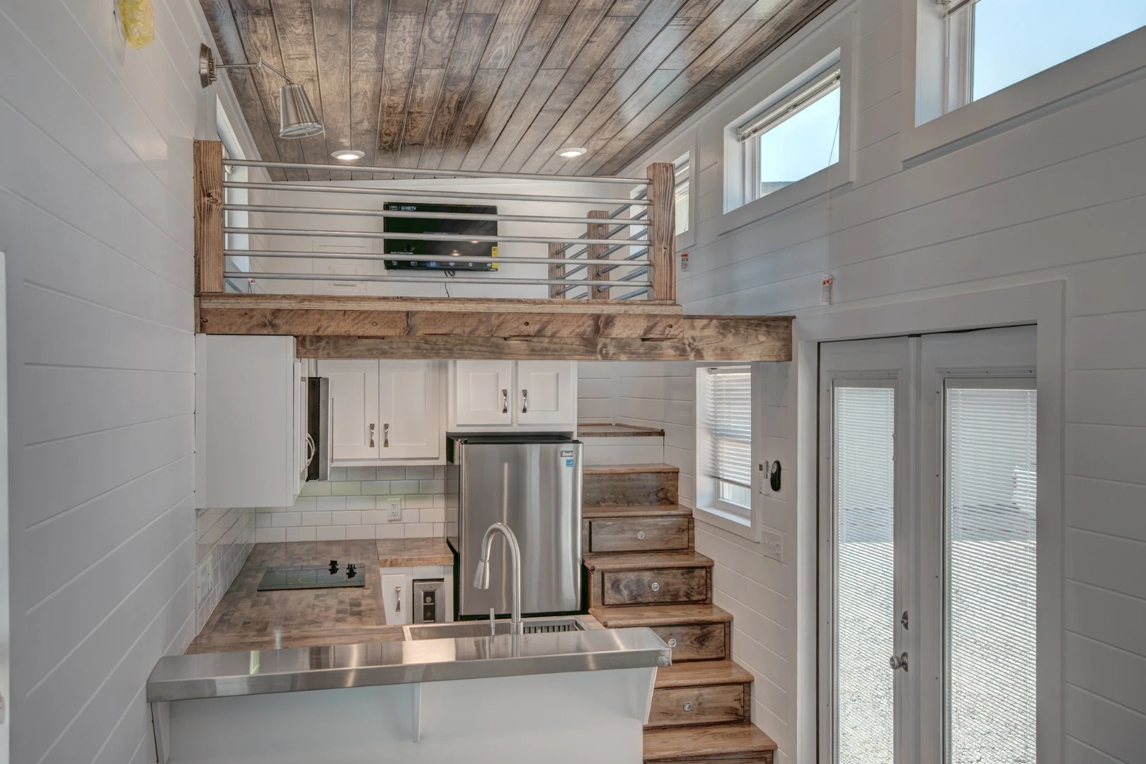 Lofts have become an almost essential component of tiny house living, but few offer the headroom of the recently completed Journey by Alabama Tiny Homes