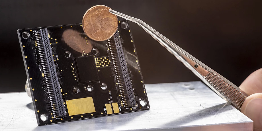The sensor, the black square in the middle of the board, measures 12 x 9 x 3 mm (0.47 x 0.35 x 0.11), a little smaller than a pair of Euro cent coins stacked on top of each other