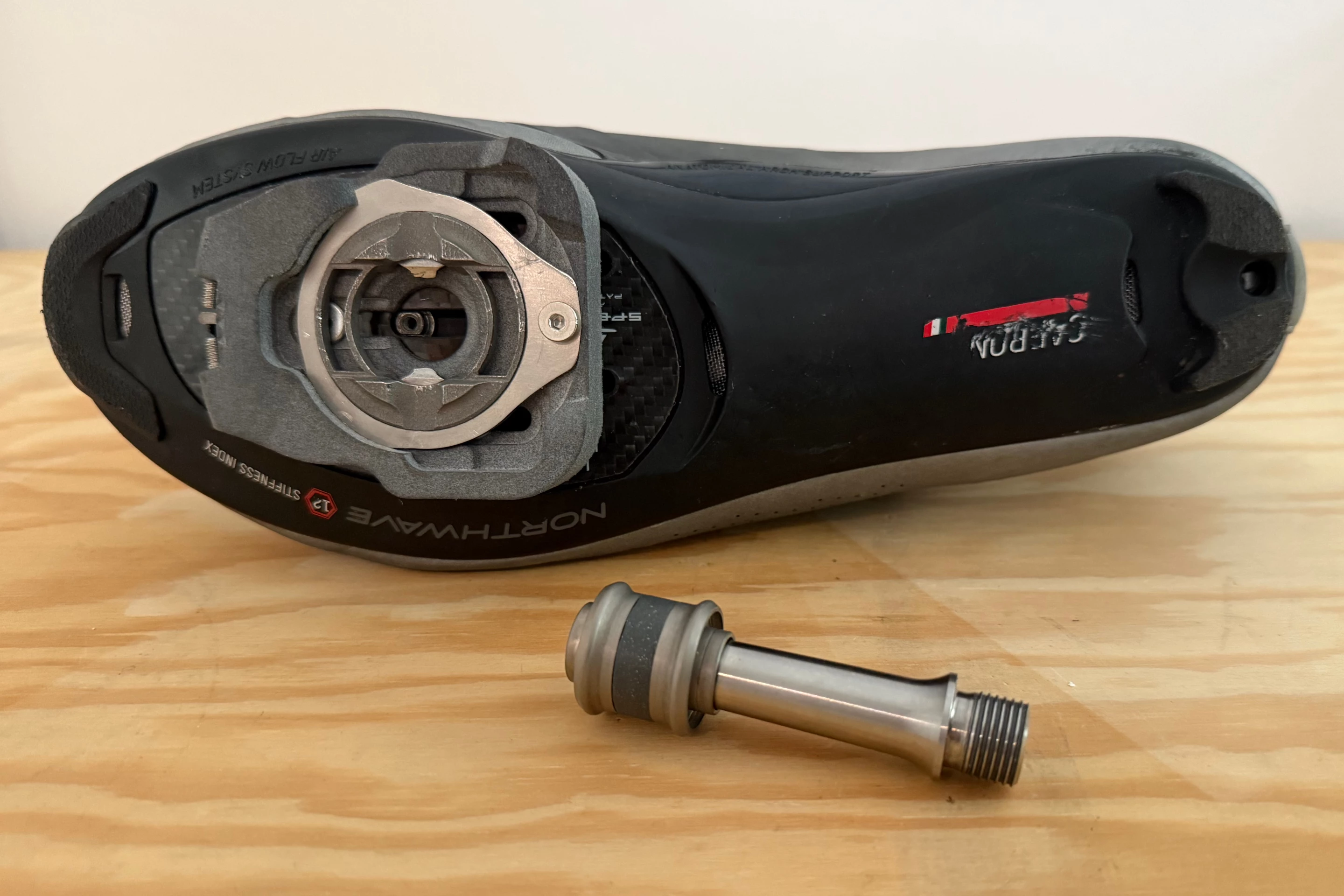 The Tourelly Road Ceramic Ti pedal (bottom) clicks into a system-specific cleat (on shoe) from any angle