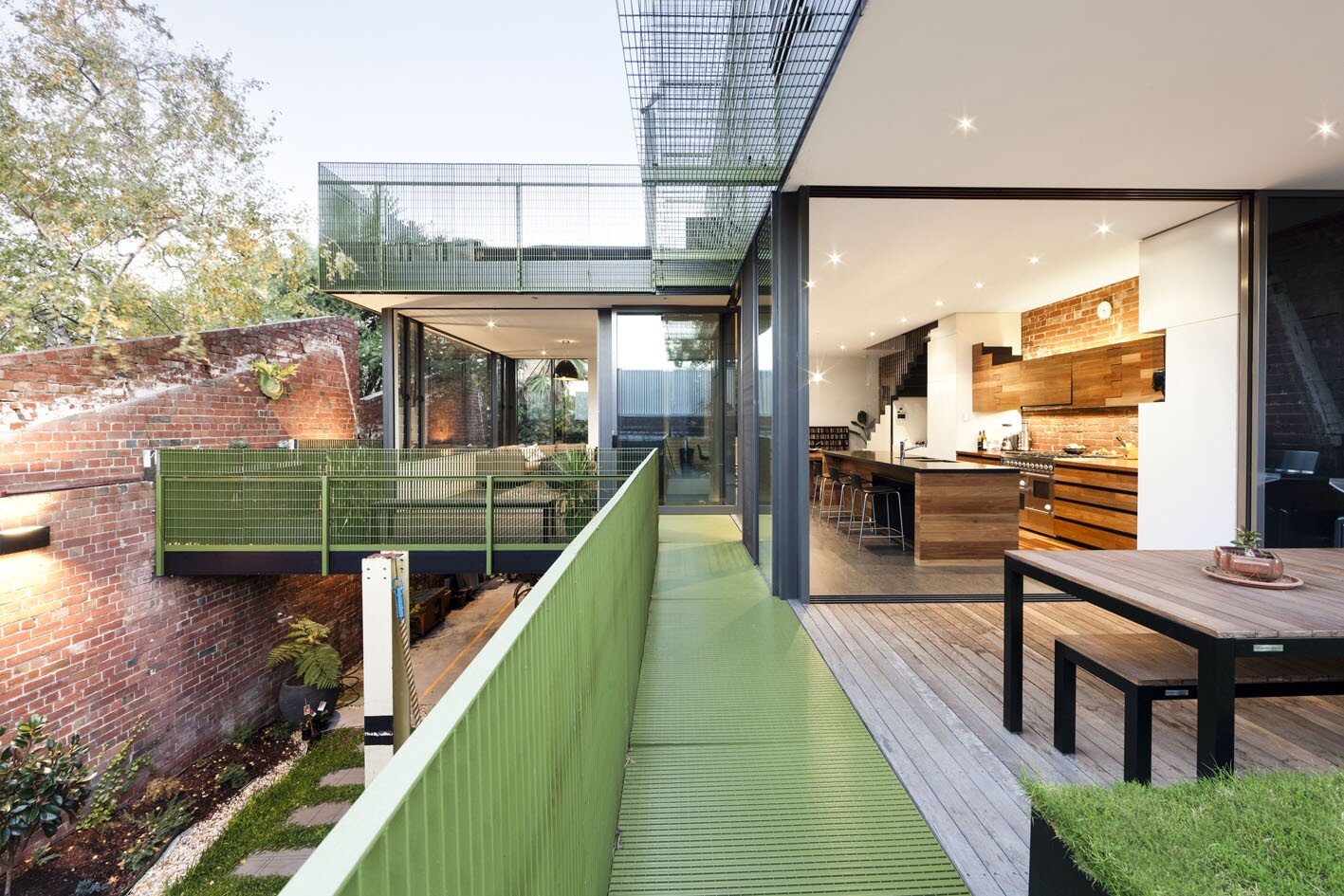 The dwelling stretches across three floors, incorporating two bedrooms, two living spaces, a study, kitchen, and several garden spaces (Photo: Brilliant Creek)