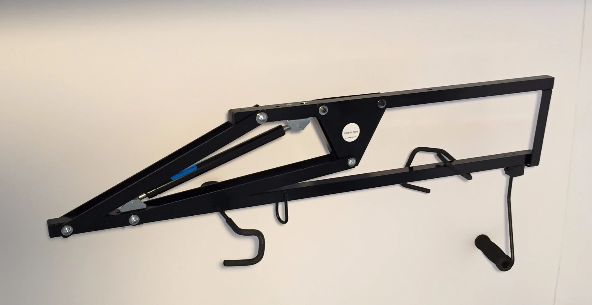 Hide-A-Ride is a mechanical rack designed to make storage a little easier by suspending bikes against the ceiling and out of the way