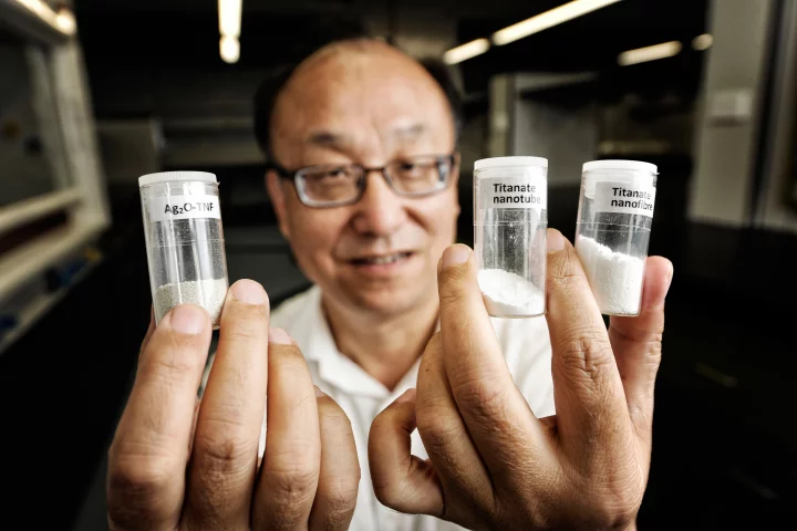 Professor Huai-Yong Zhu from QUT Chemistry with the titanate nanofiber that can remove radioactive material from contaminated water